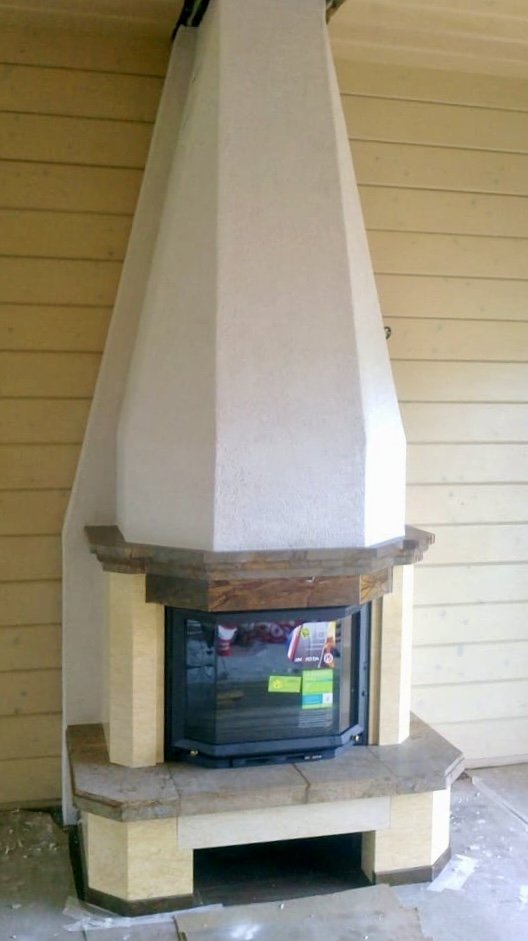 Corner fireplace with plaster hood and stone mantel (Firebrick & Stone project photo)